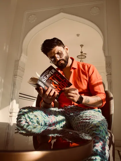 Even when posing, I like to add a bit of character. Here I am "reading" a book, adding a playful touch.