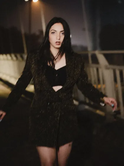 The stars come out when it is dark enough. This is from a moody night shoot on a bridge, creating a dark and atmospheric fashion story.