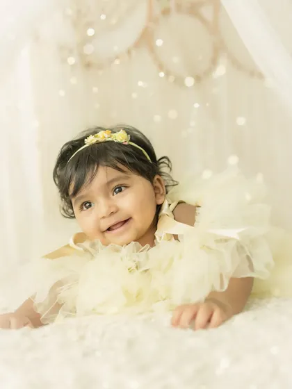 A happy, curious expression. This baby is enjoying her time in our soft, dreamy, light-filled setup.