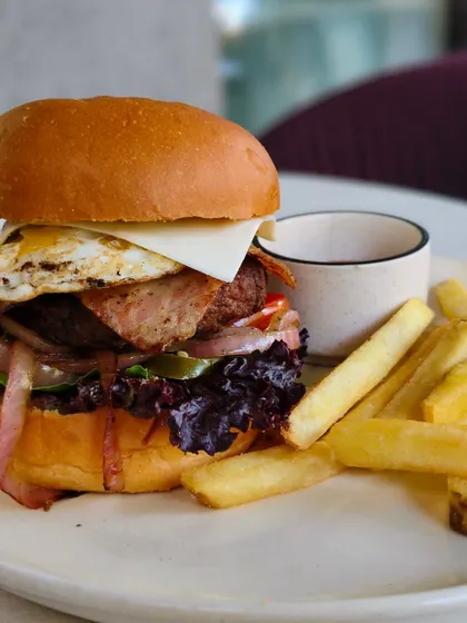 Another look at my rule-breaking burger, fully loaded and served with a side of crispy fries.