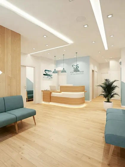 A bright and cheerful clinic waiting area with light wood floors and blue sofas. The design uses geometric shapes and a mix of materials to create a modern and friendly atmosphere.