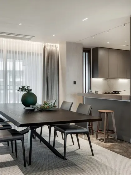 This view shows the seamless transition from the dining area to the kitchen's breakfast bar. Creating an open, flowing layout is key to encouraging interaction and making a home feel connected.