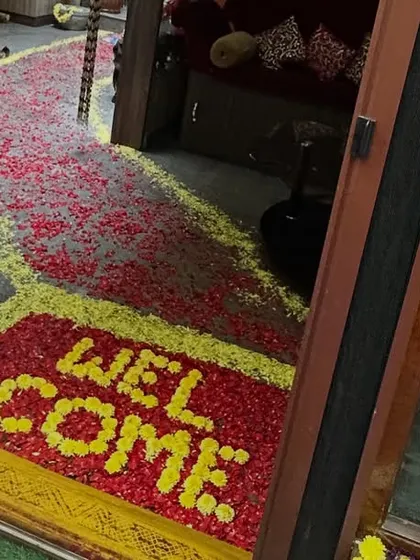 A creative and beautiful welcome message made entirely of flower petals on the floor, offering a unique and fragrant greeting to guests.