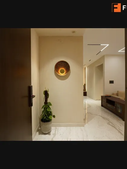A simple yet elegant entryway from our Tata Promont project, where a single piece of wall art and a potted plant create a warm and welcoming feel.