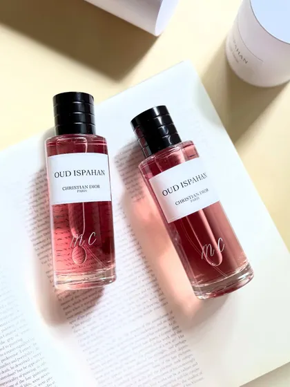 Two Christian Dior Oud Ispahan bottles, each personalized with an elegant, flowing engraved monogram. This is one of my favorite fragrances, and it's always a pleasure to add my touch to such a classic.