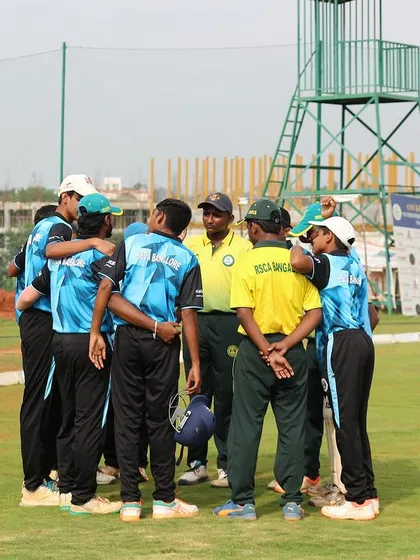 A team huddle during the RSCA Dasara Cup, with a coach providing last-minute instructions.