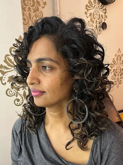 The side view shows the layers and movement in her new curly style.