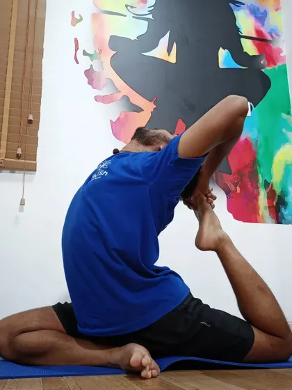 A deep hip and back-opening pose, demonstrating an advanced level of flexibility.
