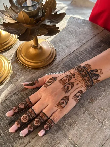 The back of the hand for the bird cage design, featuring hanging cages and a peacock wristband, creating a cohesive and unique theme.