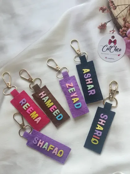 A collection of our felt name keychains, perfect for adding to our Eidi cards. We can customize them with any name and in various colors.