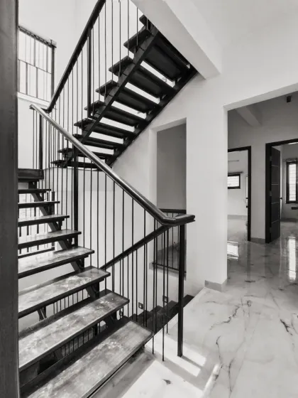 A staircase is more than just a way to get from one floor to another; it can be the sculptural soul of a home. We designed this floating metal staircase to be a light-filled, focal element. Its clean lines and strong form add a modern, industrial character to the space.