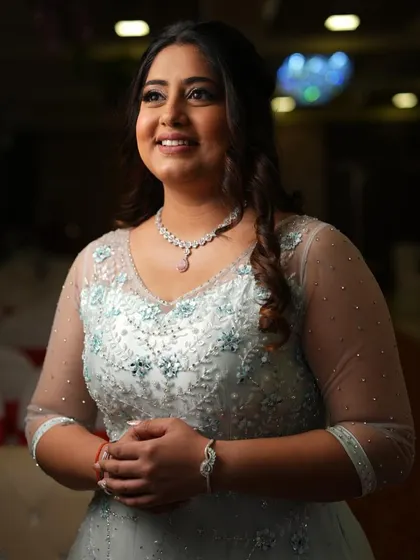 A classic portrait from her engagement. The soft lighting highlights the subtle shimmer in her makeup and the intricate details of her gown.