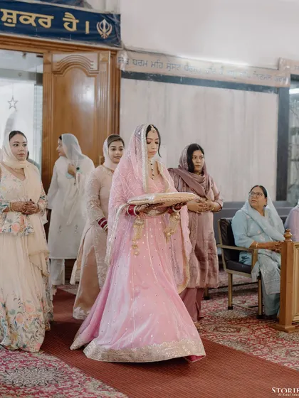 The bride's entrance at her Anand Karaj, a moment of grace and tradition.