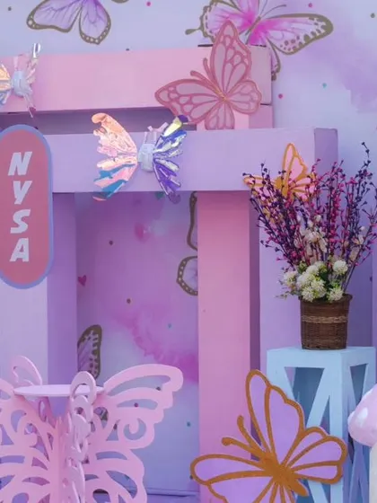A close-up of the pastel butterfly backdrop, showing the holographic and 3D butterflies that add a touch of magic and sparkle.