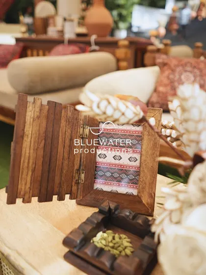 A small wooden photo frame and other rustic props add a personal touch to the decor.