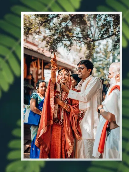 A joyful moment from a wedding ceremony, where the bride points to the sky during a ritual.
