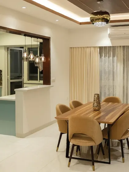 Our client envisioned a dining area that was both functional and inviting. We created an open-concept layout connecting to the kitchen, with a modern wooden table, plush chairs, and a breakfast bar for a spacious and connected feel.