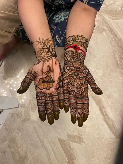 Another lovely Teej design with the iconic 'girl on a swing' motif. This design is paired with a more traditional floral pattern on the other hand, offering a unique combination.