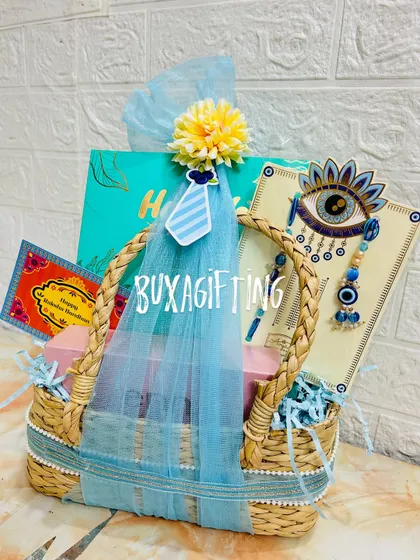 A close-up of the Bhai-Bhabhi Rakhi hamper, focusing on the vibrant blue color scheme and the evil eye rakhi set.