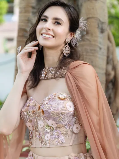 The flowing cape and soft hair add a touch of modern romance to this elegant morning look.