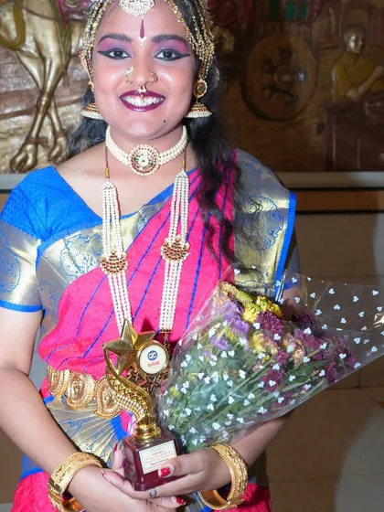 A proud moment for the artist, holding her trophy and bouquet after a successful performance. I make sure to capture these moments of achievement and celebration.