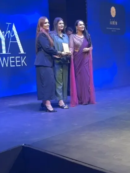 On stage at Seeya Fashion Week, receiving an award with my team. This recognition is a testament to our hard work and dedication to style.