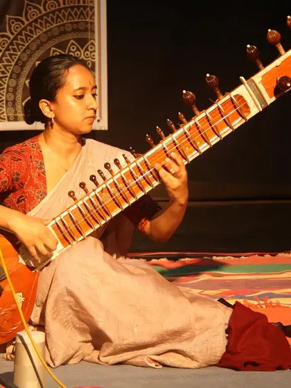 A student lost in her music during a performance. My goal is to teach not just technique, but how to feel and express the emotion of the raag.