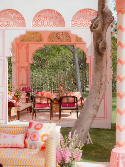 A lounge area set within a 'Gulbahar' archway, featuring chevron-patterned pillars and custom-printed cushions. The design was a contemporary take on traditional Rajasthani architecture.
