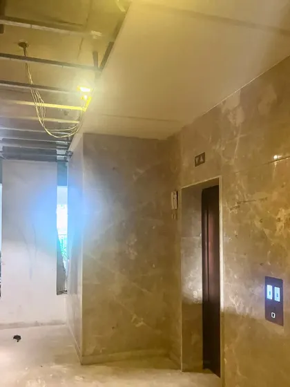 The elevator lobby at "The Corridors" project taking shape. Here, the marble-clad walls are being installed, giving a first hint of the luxurious and exclusive atmosphere we designed for this grand entrance.