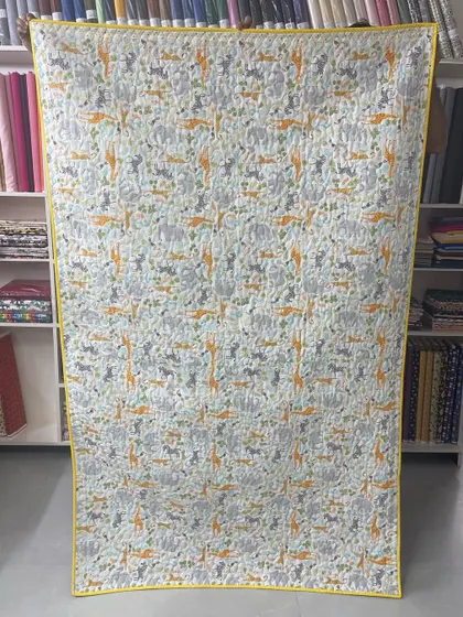 The back of the elephant quilt, featuring a playful animal-print fabric.