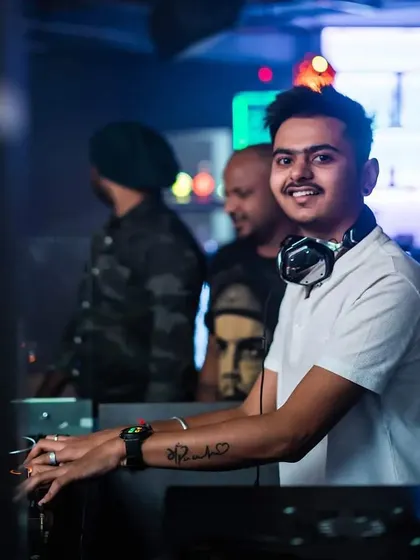 A smile is your only weapon. A simple, happy shot of me at the console, ready to bring good vibes to the dance floor.
