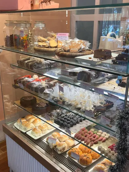 Our Christmas display, fully stocked with a variety of holiday bakes, from cakes and cookies to savoury buns.