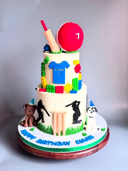 A still shot of the custom cake for Kiaan, featuring a cricket theme with Lego blocks and his favorite pets. It's a great example of how we can personalize a cake to be truly unique.