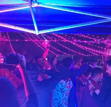 Capturing a fun moment at the Diwali party, with colorful lighting adding to the festive atmosphere.