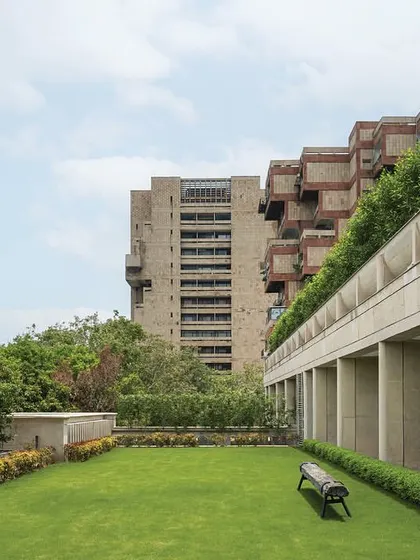 The top-floor terrace offers a green retreat with a manicured lawn, providing a space for relaxation and events with views of the surrounding cityscape.