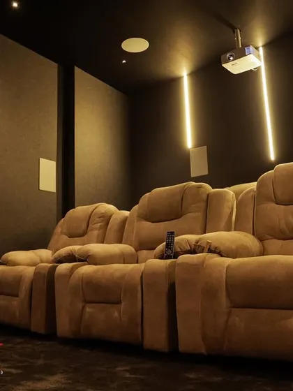 This wide shot shows how even a relatively small room can be transformed into a fully functional and comfortable home cinema.