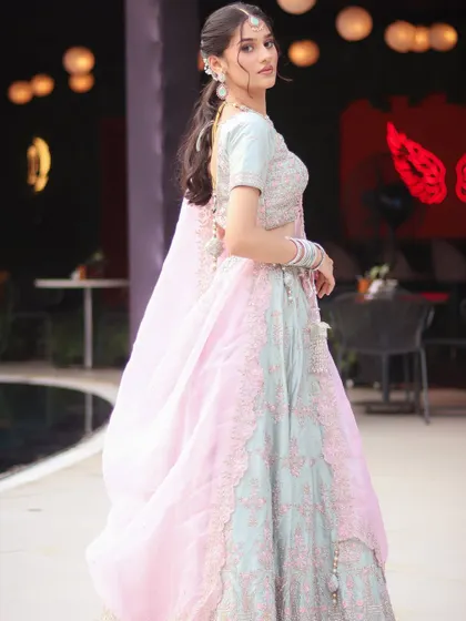 A full-length shot of the pastel pink and blue lehenga, a perfect inspiration for an engagement look.