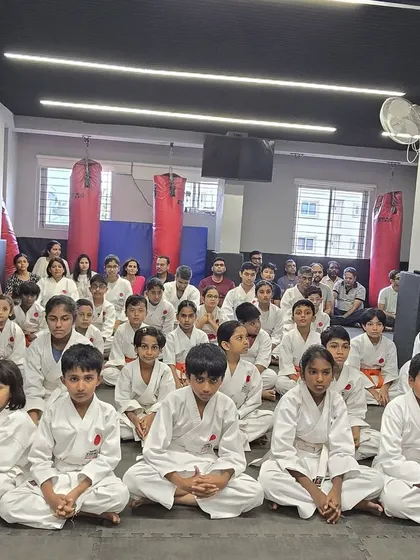 Our younger students sitting with focus and discipline during a seminar. We believe in exposing them to the formal traditions and community aspects of karate early on.