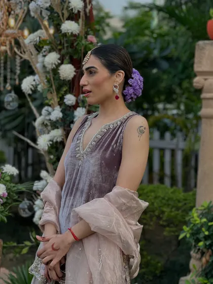 A beautiful velvet sharara suit I designed for my brother's wedding. The purple flowers in my hair add a soft, romantic touch to the rich velvet fabric.