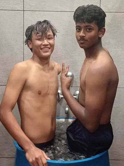 Two players posing during their ice bath therapy. These sessions help reduce inflammation and muscle fatigue, keeping our athletes ready for the next challenge.