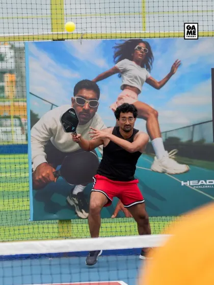 A player hits a backhand in front of our vibrant court-side branding. The energy at our events is contagious.