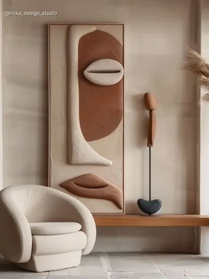 Art is essential for adding personality to a space. This corner features a large, textural piece of sculptural wall art with earthy tones and organic shapes, instantly elevating the room and creating a sophisticated focal point.
