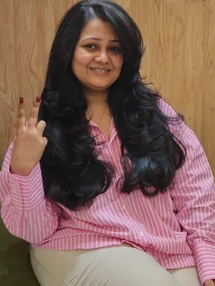 The client's happy expression and peace sign say it all. She loves her new layered haircut and voluminous style, created by my team at the Khar salon.
