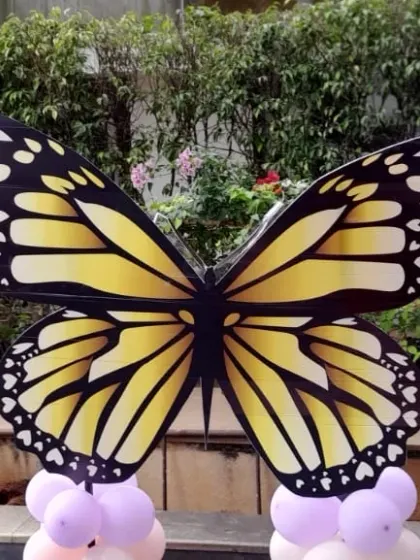 A large monarch butterfly prop used as a photo opportunity for a themed birthday party.