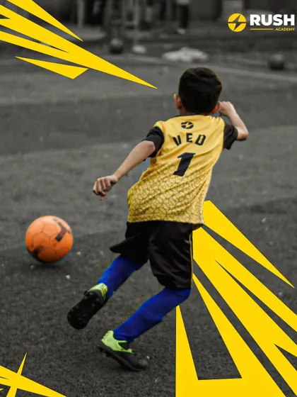 A young player strikes the ball, showcasing developing technique.