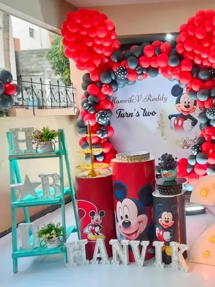 A wider view of the Mickey Mouse second birthday setup, including a light-up marquee number "2".