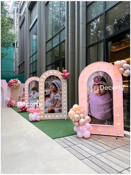 A walkway lined with illuminated photo frames, creating a personal and touching gallery for the birthday girl and her family.