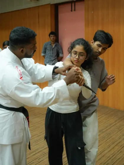 This is a close-up view of a knife defense drill. We teach students how to control the weapon-bearing limb and create leverage to neutralize the threat safely and efficiently.