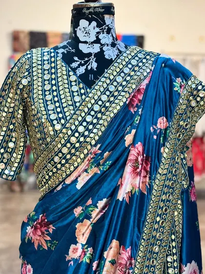 The blouse of the 'NIKHAAR' saree is a statement piece in itself, covered in intricate mirror work that catches the light beautifully.