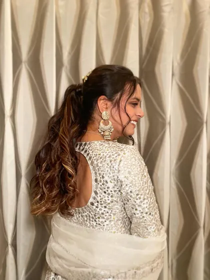 A side view of the textured ponytail with stone clips, showing how it adds a touch of glamour to the overall look.